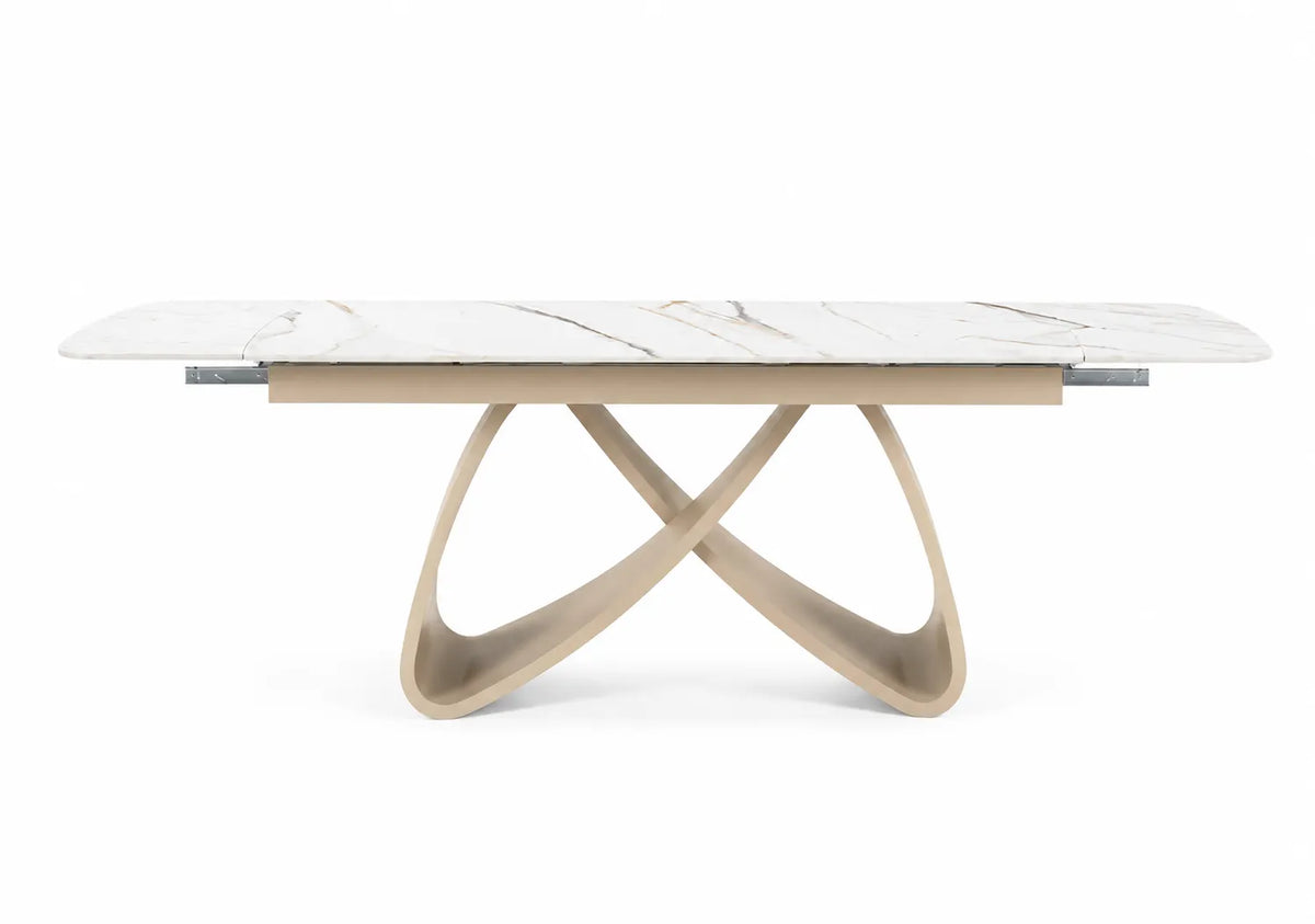 Tavolo allungabile Eros con piano in ceramica effetto marmo oro lucido e struttura in metallo color Champagne da 180 a 260 cm.