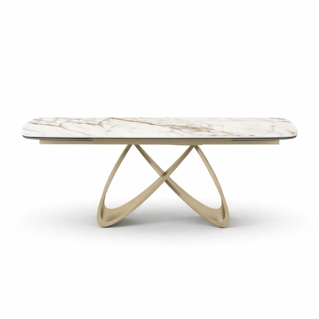 Tavolo Wings allungabile in ceramica effetto marmo calacatta con base intrecciata color champagne